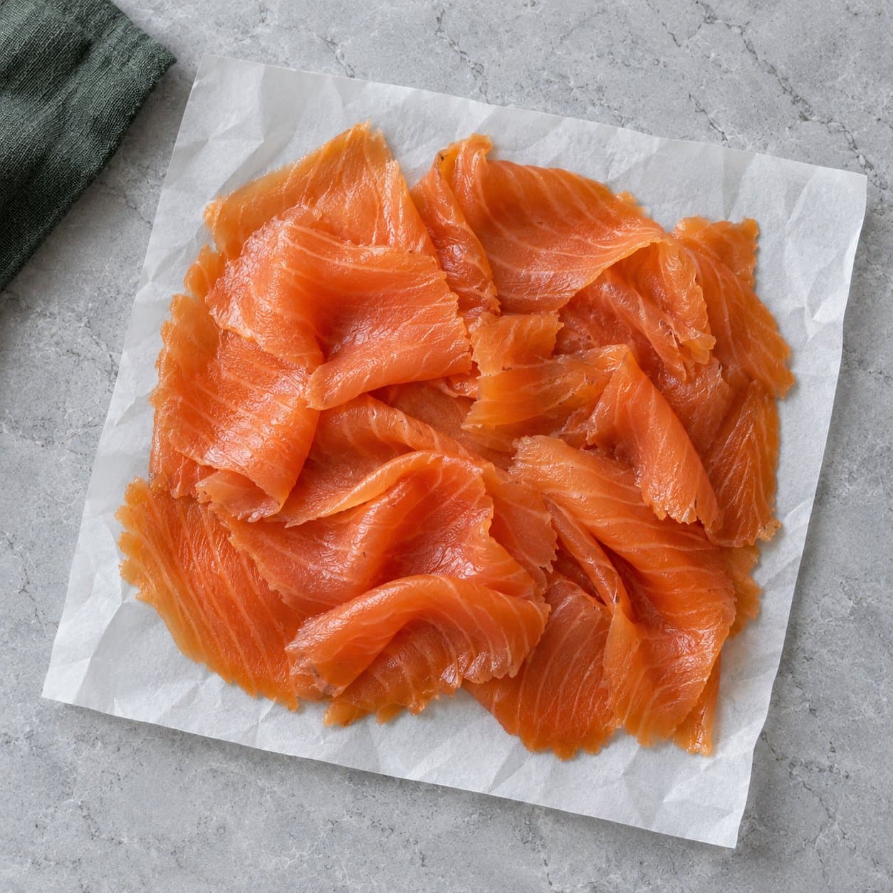 Sliced smoked salmon on white paper